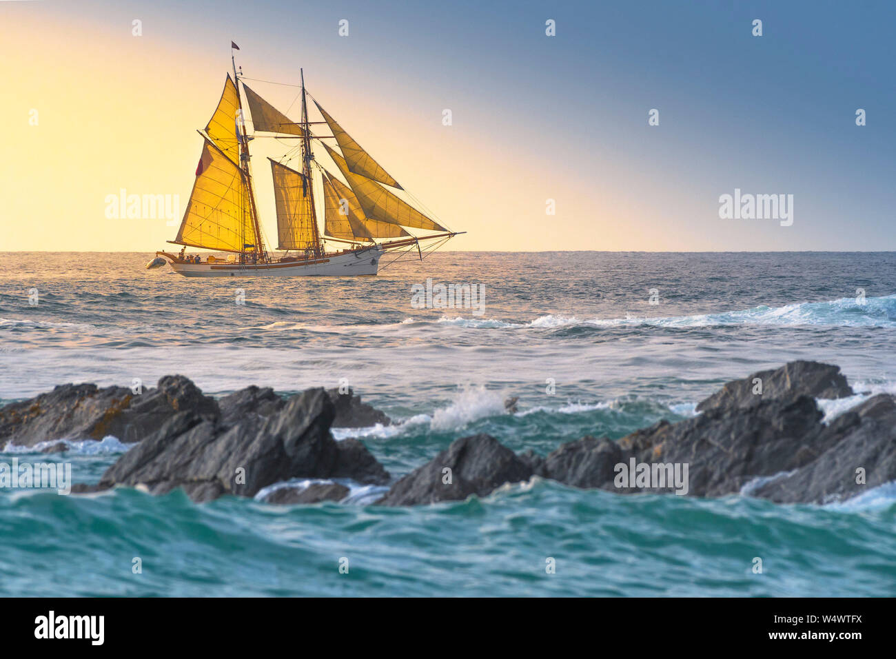 The schooner Anny owned by Rolf Munding under full sail sailing past Fistral in Newquay in Cornwall. Stock Photo