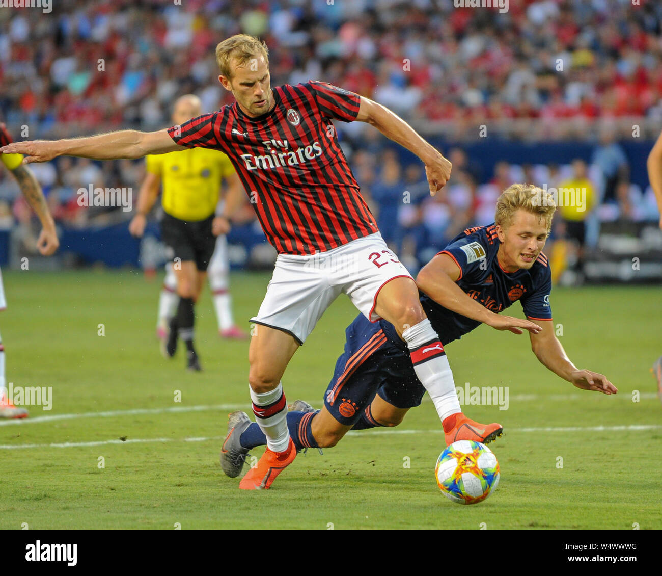 Kansas City, KS, USA. 23rd July, 2019. AC Milan defender, Ivan Strinic  (23), and Bayern forward, Fiete Arp (15), clash while working for ball  control during the 2019 International Champions Cup match