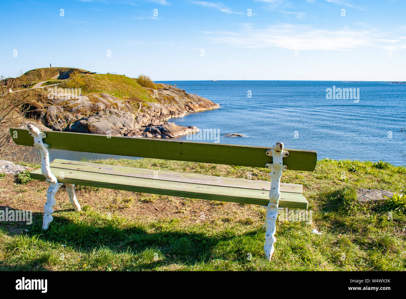 Beautiful finnish landscape, Suomenlinna, Helsinki, Helsingfors, Uusimaa, Finland with rocks and Baltic Sea with wooden bench Stock Photo