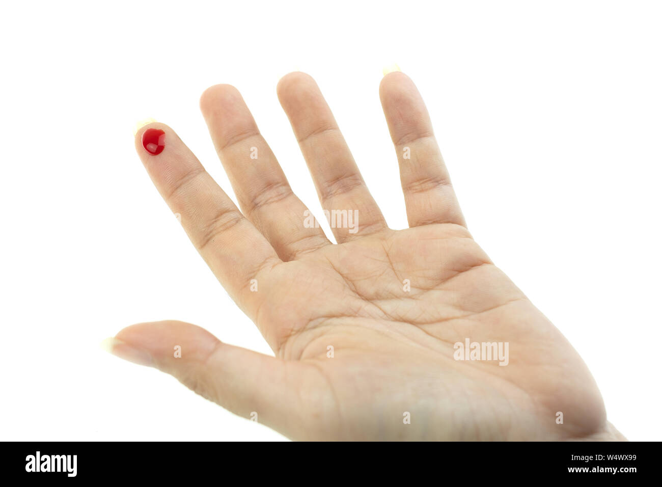 Bleeding red blood from the cut finger wound at white background Stock