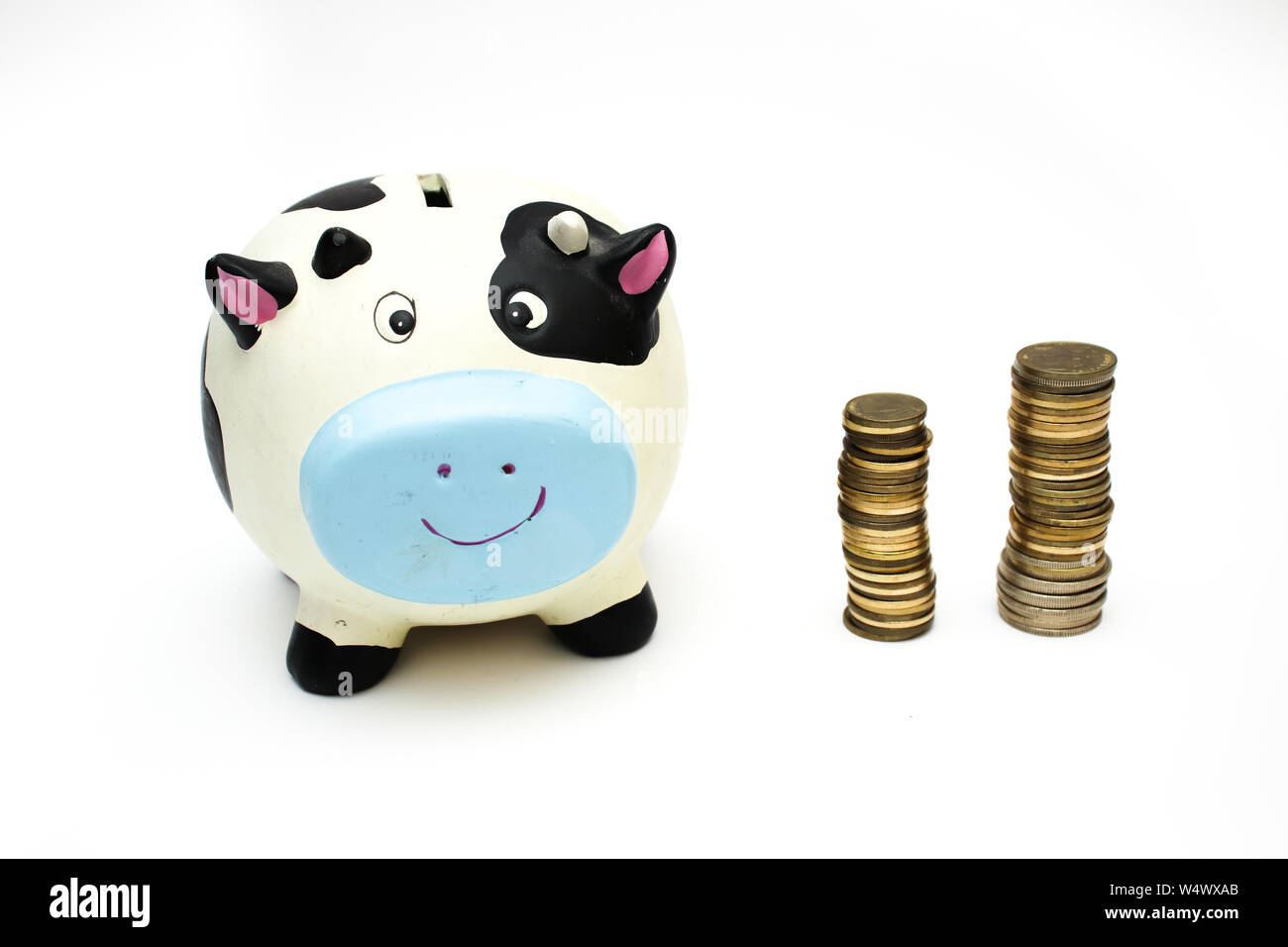 Piggy bank and coins on white background Stock Photo - Alamy