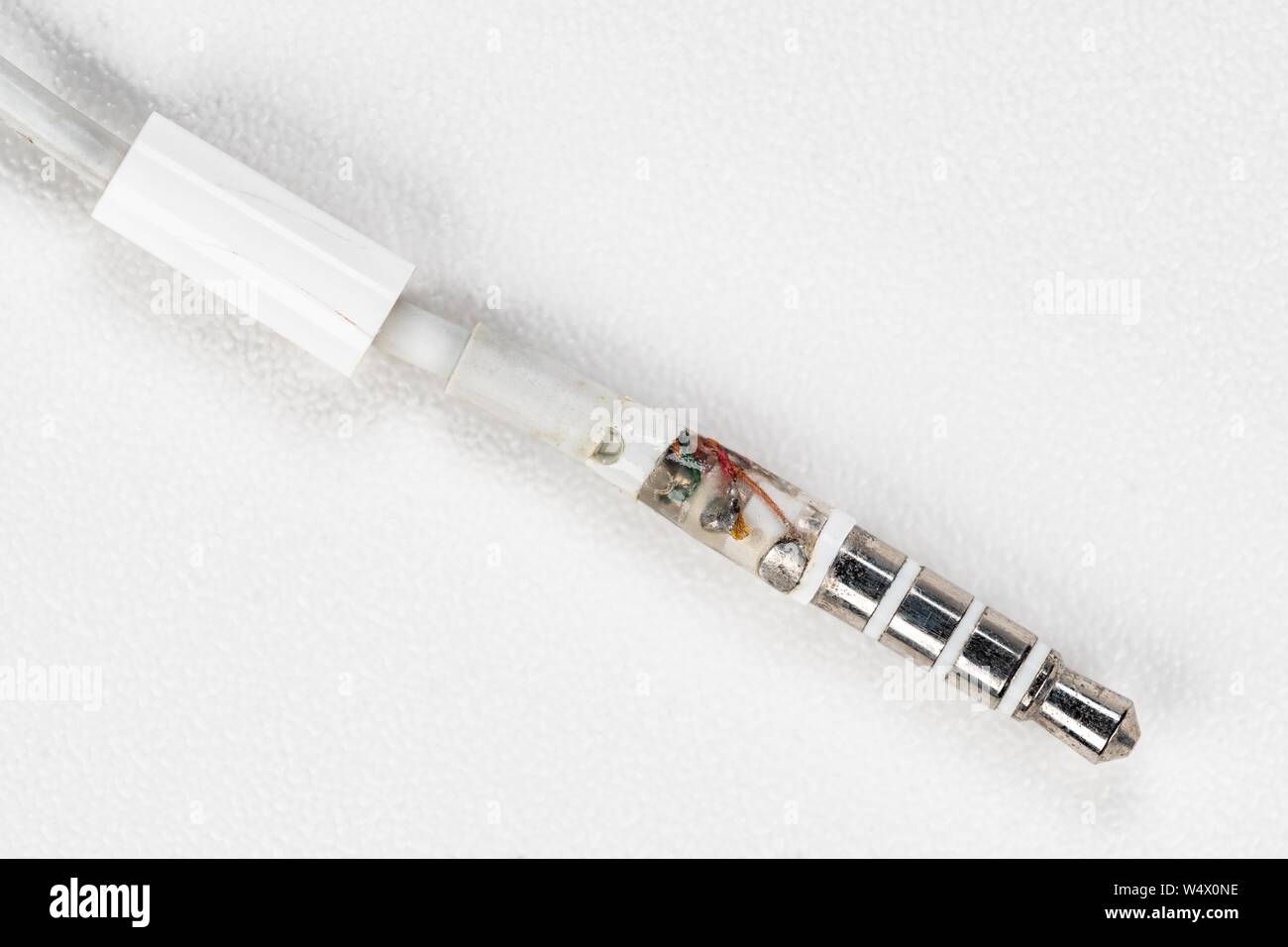 Close-up a broken headphone jack on white background. Stock Photo