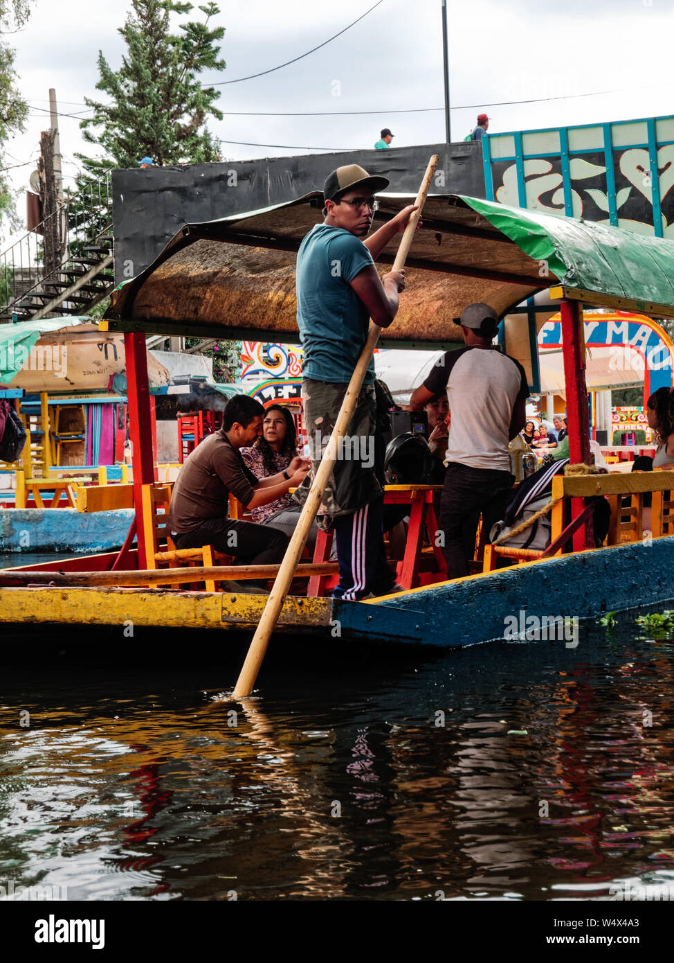 Xochimilco, Mexico City, June 25, 2019 - Young trajinero rowing the trajinera for Xochimilco's tourists Stock Photo