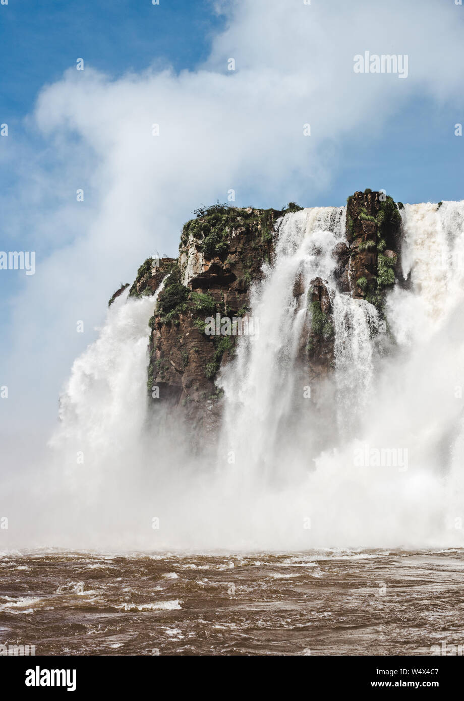 Powerful gushing water of Iguazu Falls, Argentina on a sunny day Stock Photo
