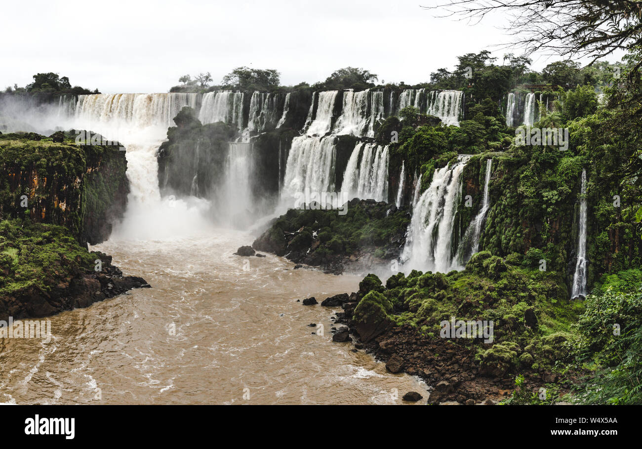 Powerful gushing water of the multiple cascading waterfalls of Iguazu Falls, Argentina on a sunny day Stock Photo