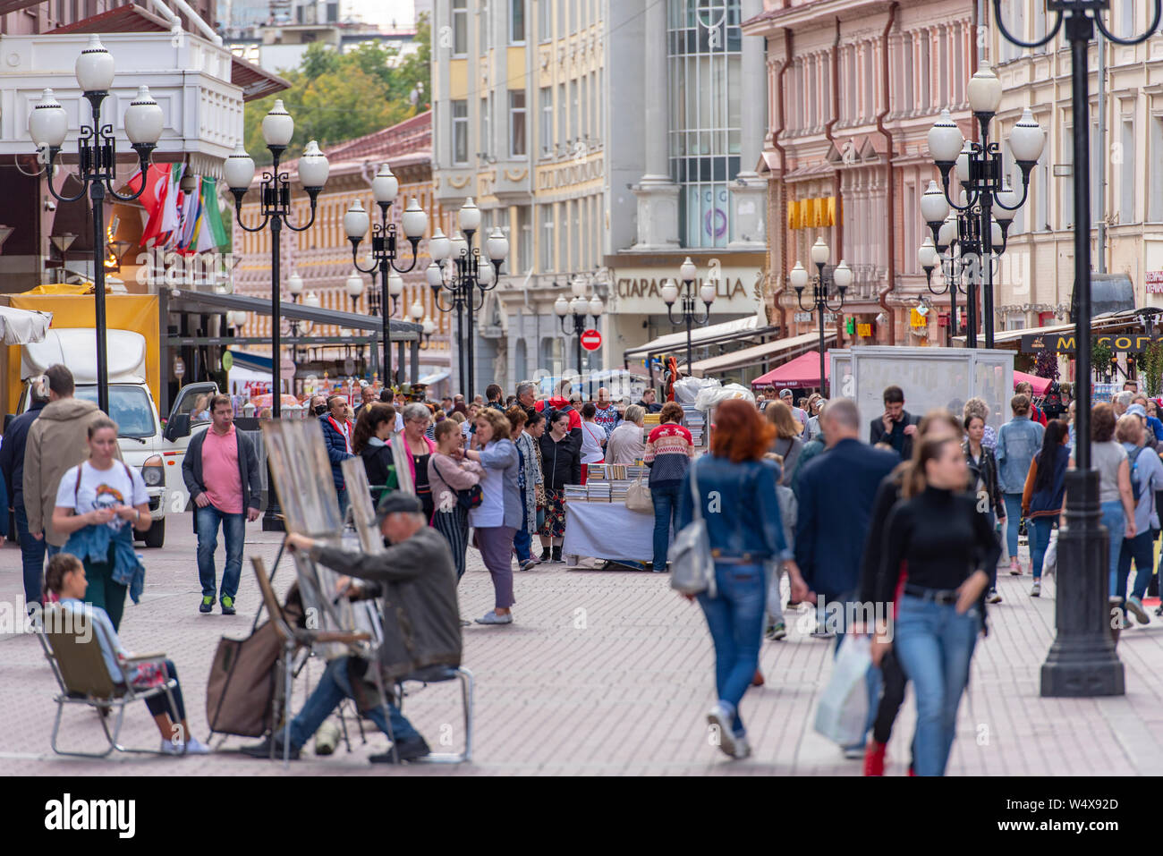 MOSCOW - JUL 19: Old Arbat Street with Souvenir Shops and Tourists in Moscow on July 19. 2019 in Russia Stock Photo