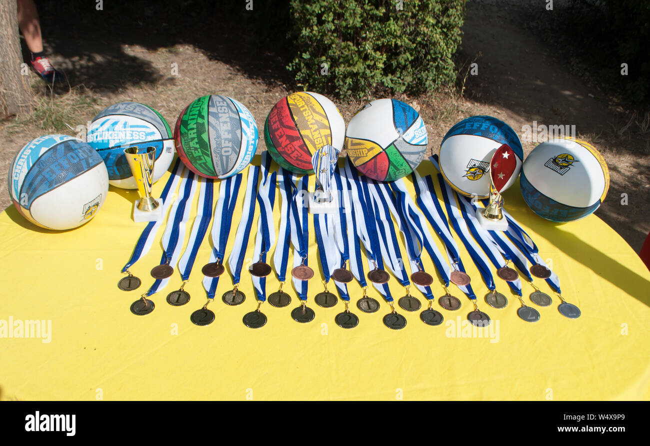 Odesa rgn. Ukraine, August 8, 2018: Basketball and soccer balls, medals, cups, as awards prepared for a football match, lying on the table Stock Photo
