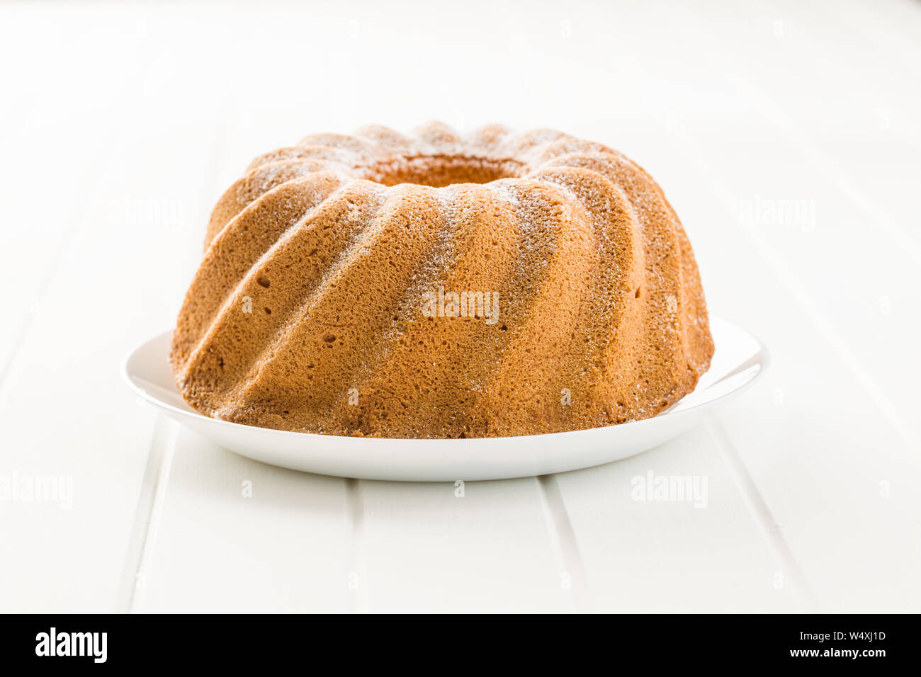 Sweet bundt cake on white table. Stock Photo