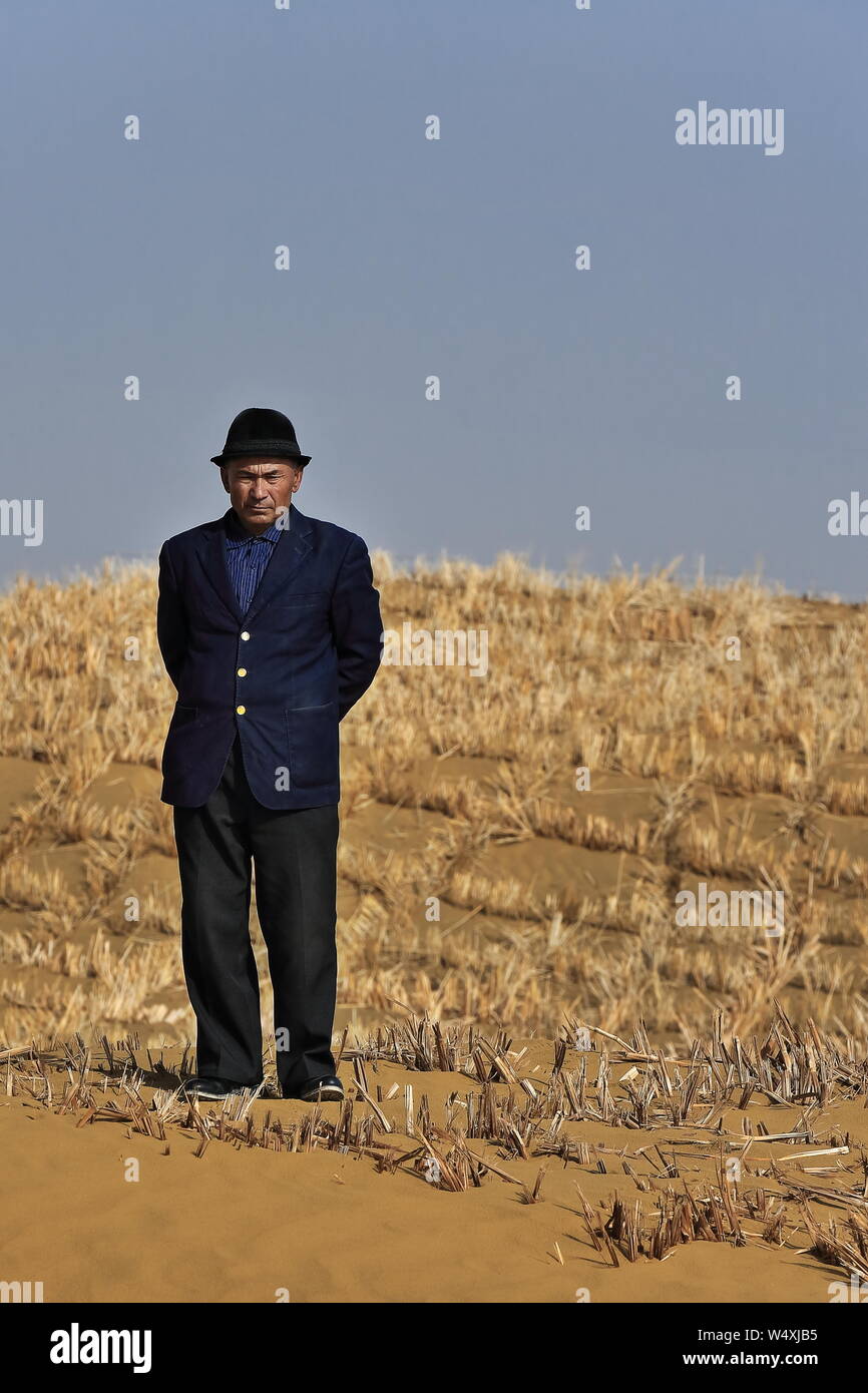Uyghur man with black hat-tourist bus driver. Taqie Highway-Taklamakan Desert-Xingjiang-China-0386 Stock Photo