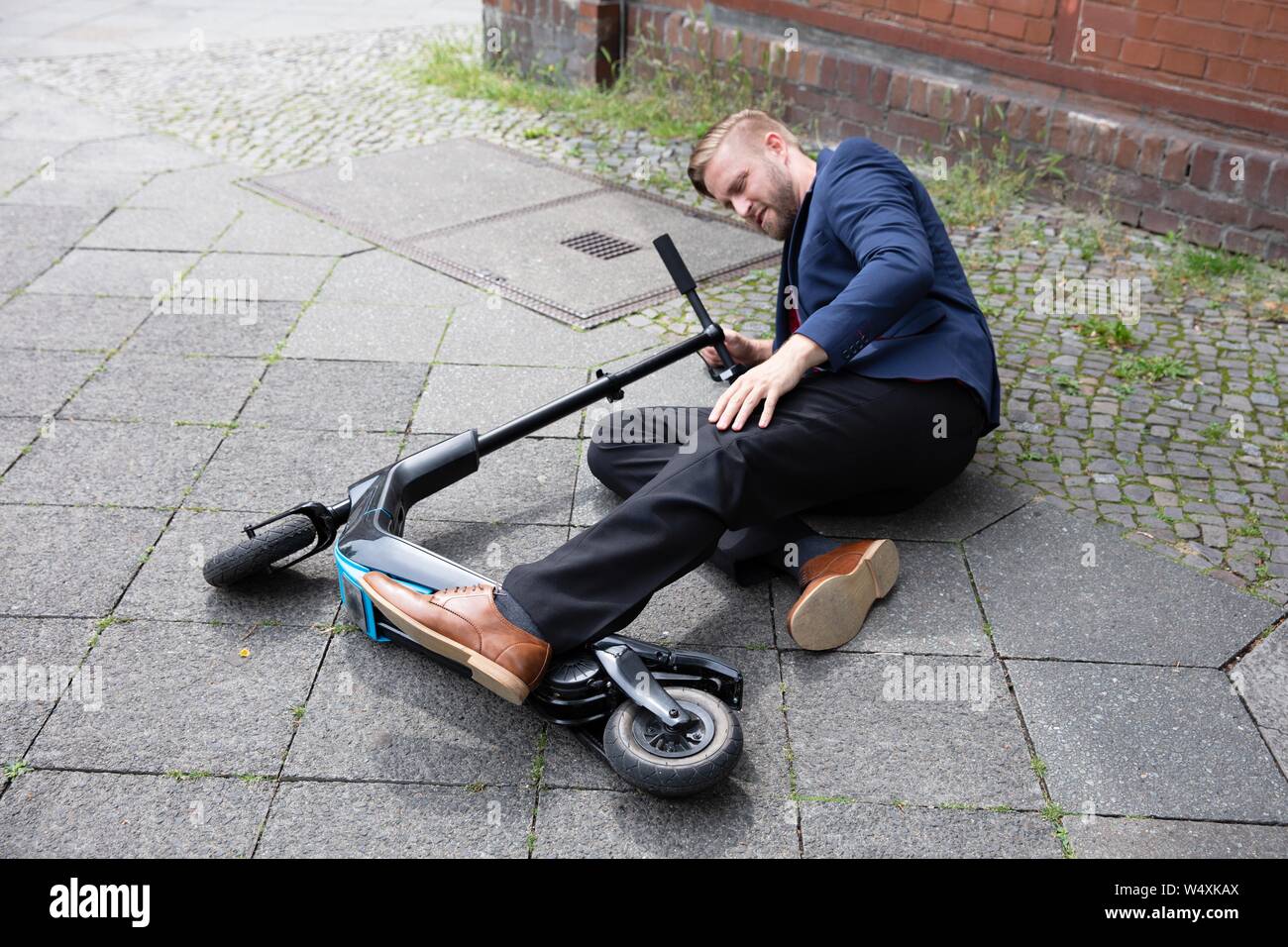 Young Man Accident With An Electric Scooter On Street Stock Photo