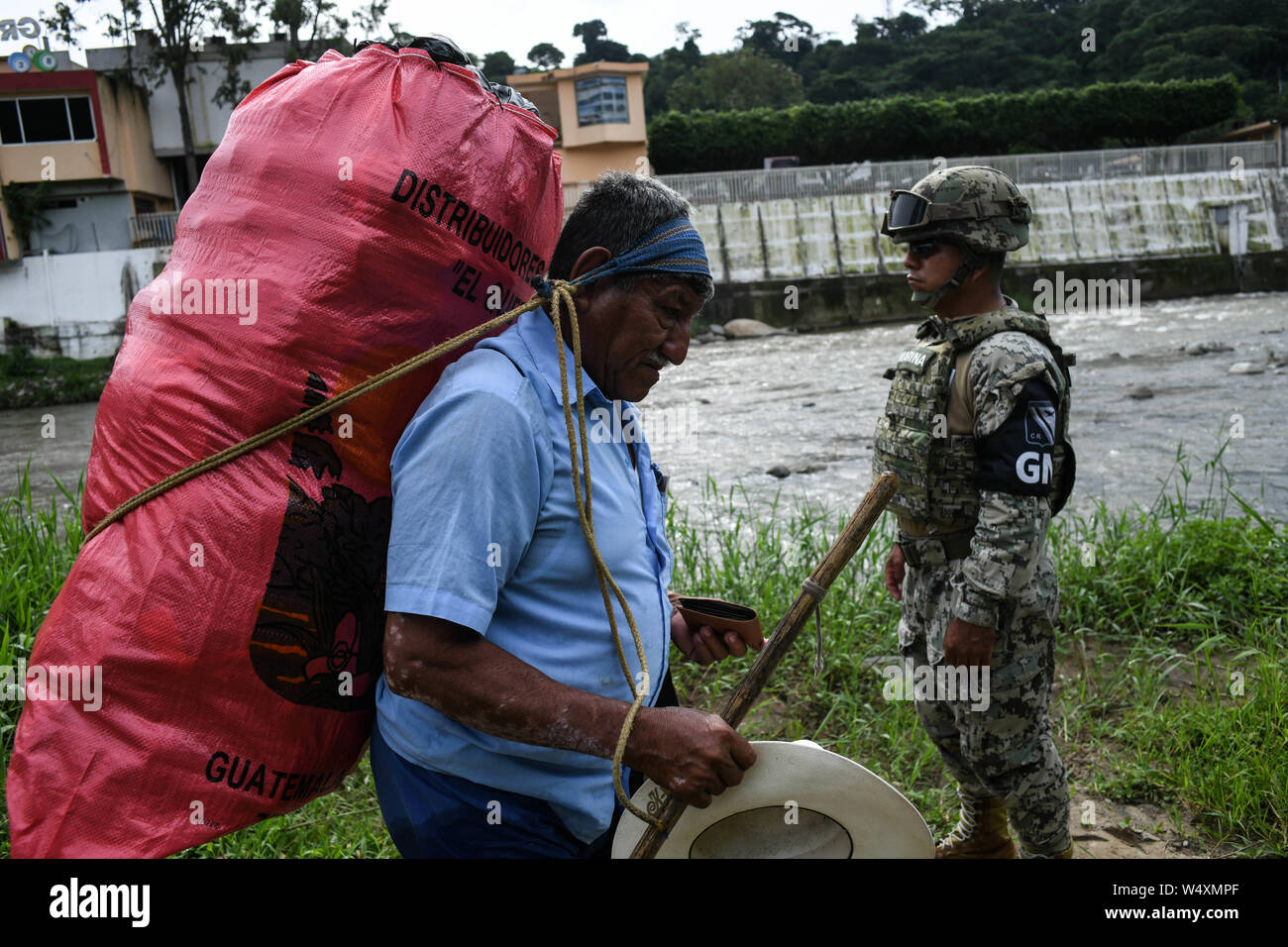 July 24, 2019, Talisman, Chiapas, Mexico: Mexican marines and immigration officers check IDs of Guatemalan porters crossing goods illegally into Mexican territory on Wednesday. Hundreds of such crossings happen every day as the flow of migrants has moved to isolated spots along the Suchiate River, which marks the border between the two nations. Mexican President Lopez Obrador's administration claims to have reduced the flow of migrants looking to reach America, but much of the flow continues in remote border areas. Credit: Miguel Juarez Lugo/ZUMA Wire/Alamy Live News Stock Photo