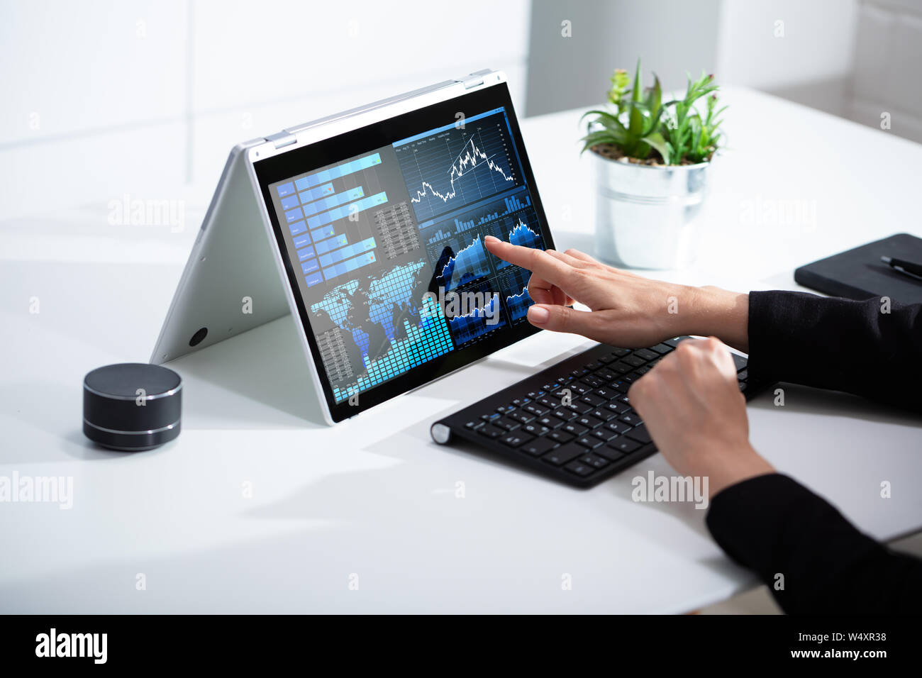 Close-up Of Businesswoman Analyzing Graph On Laptop At Workplace In The Office Stock Photo