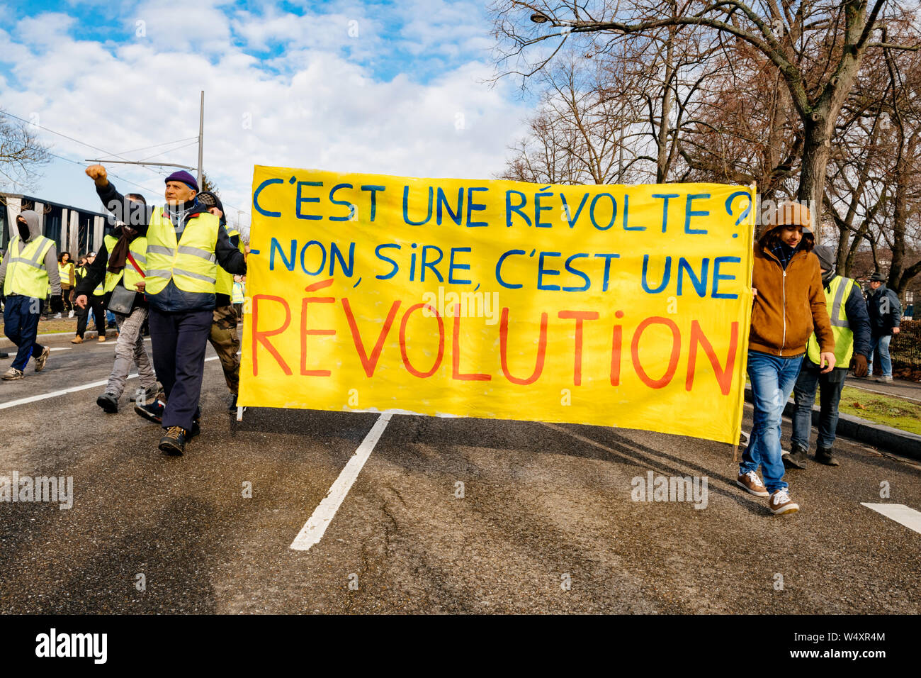STRASBOURG, FRANCE - FEB 02, 2018: People marching during protest of Gilets  Jaunes Yellow Vest manifestation anti-government demonstrations with this  is a revolution placard Stock Photo - Alamy