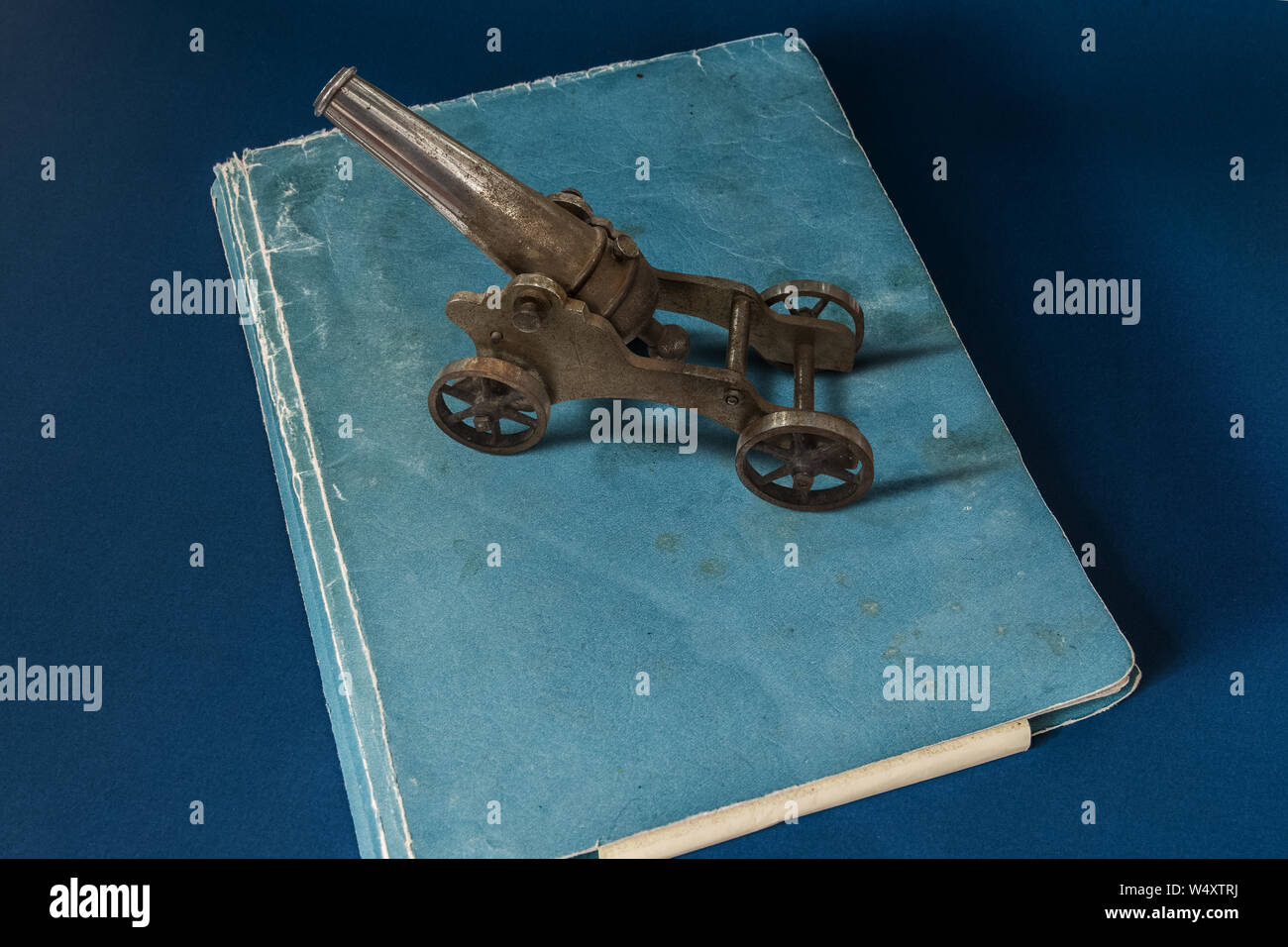 A small black powder cannon on top of a file. Stock Photo