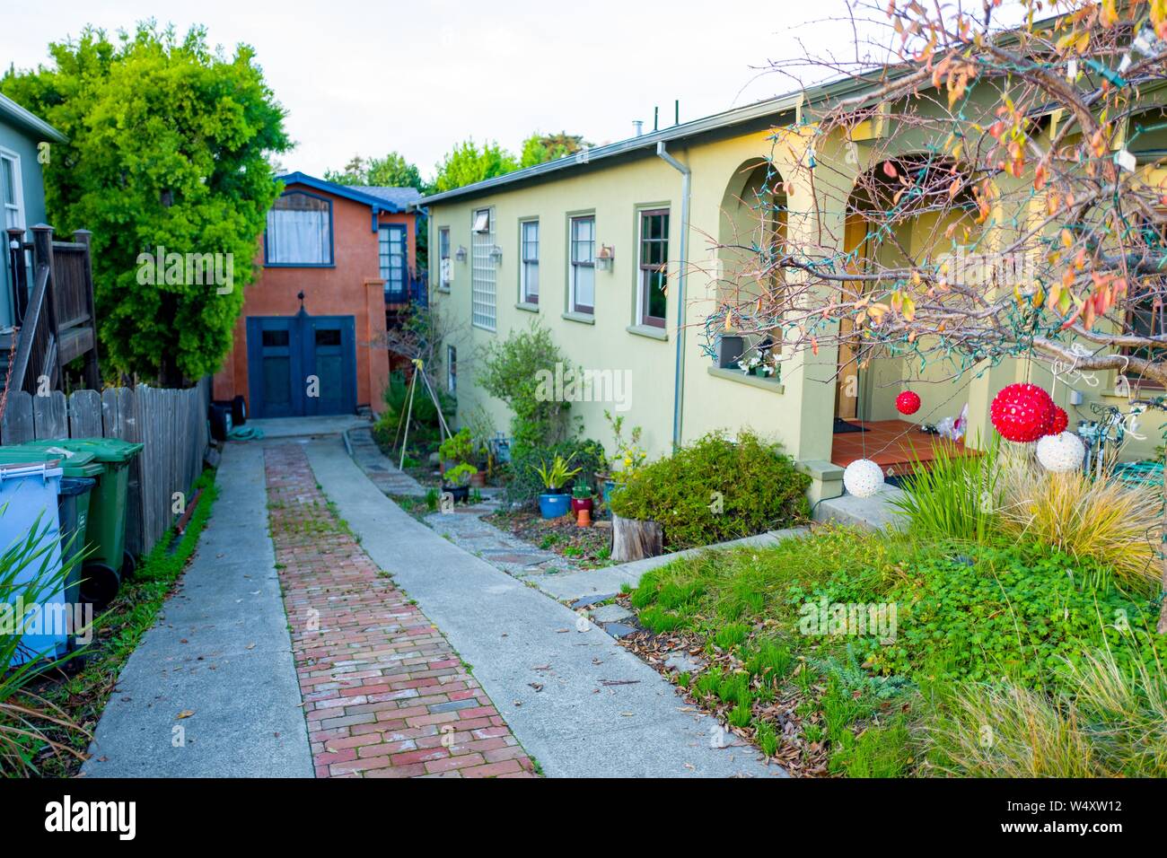 View down driveway of a large home towards a presumed Accessory Dwelling Unit (ADU), commonly known as an In Law unit in a a converted garage in Berkeley, California, December 18, 2018. ADUs are a controversial architectural feature in Berkeley, where they are often constructed to increase housing density in the popular San Francisco Bay Area suburb. () Stock Photo