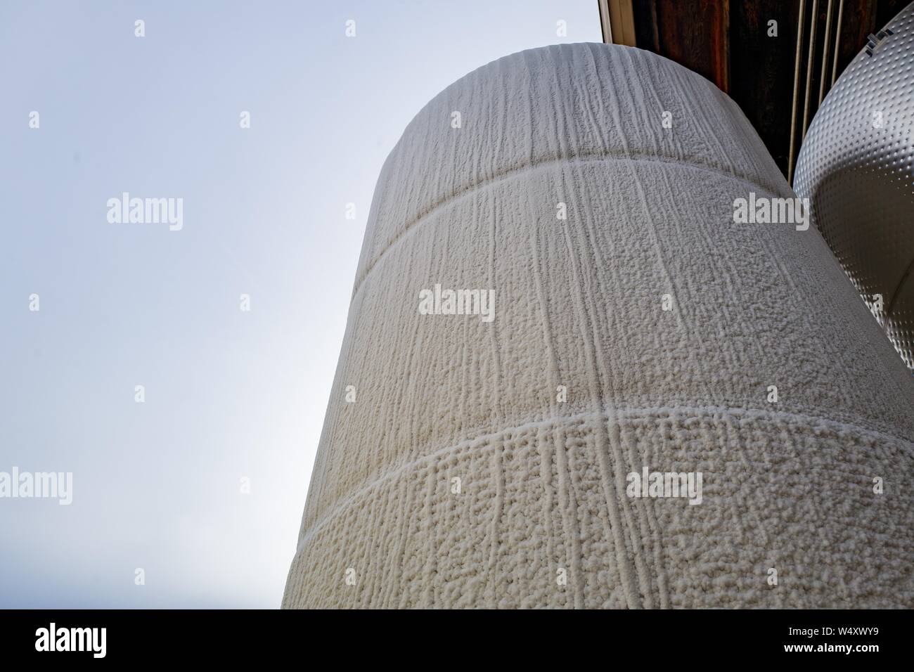 Low-angle view of large stainless steel tank covered in frost at a wine production facility in Sonoma County, Healdsburg, California; the tank is chilled below freezing and filled with wine in order to stop fermentation and hold the finished wine until it is able to be bottled, December 22, 2018. () Stock Photo