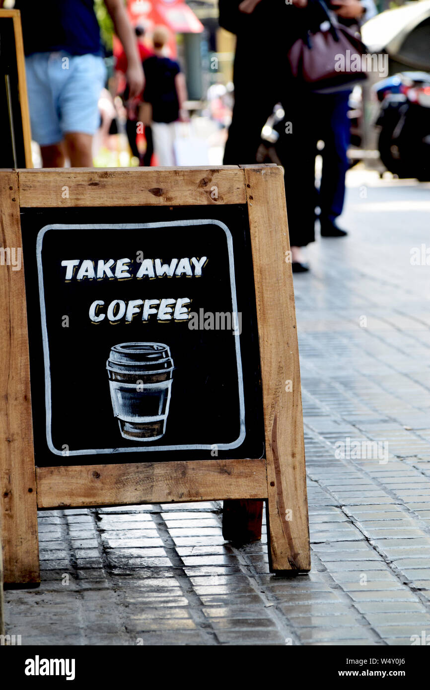 Take away coffee written on sidewalk sandwich board outside cafe in the city Stock Photo