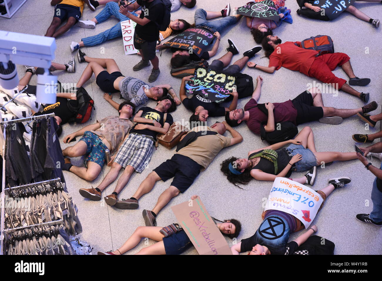 Activists lay on the ground pretending to be dead in a performance during the protest.Extinction Rebellion activists gathered at Gran Via Primark store in Madrid to protest against textile industries, and to demand to the Spanish government to act against the climate change. Stock Photo
