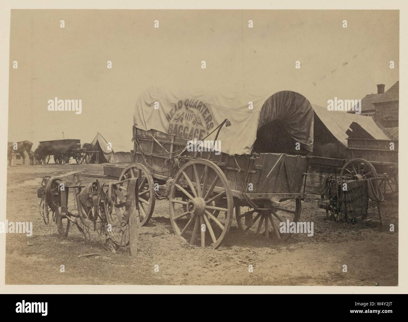 Covered wagon for ‘Headquarters baggage‘ and saddlery, probably a Civil War military camp Stock Photo