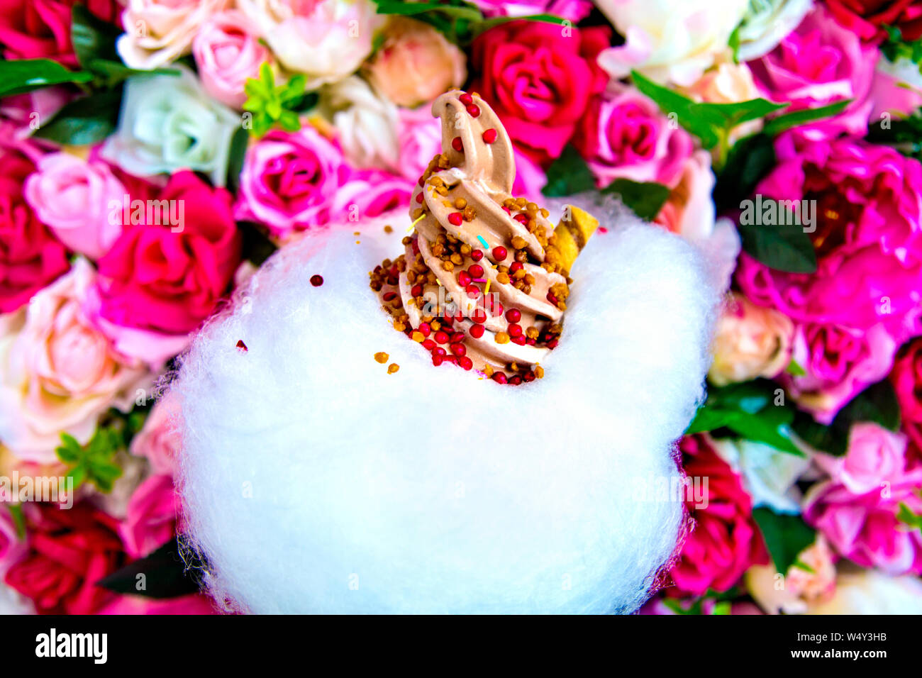 Chocolate soft serve ice cream with strawberry and caramel sprinkles and cotton candy cloud at Milk Train, London, UK Stock Photo