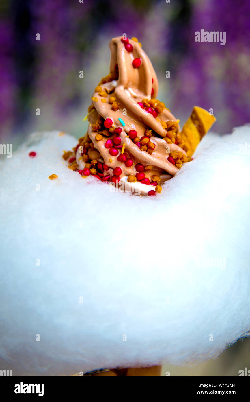 Chocolate soft serve ice cream with strawberry and caramel sprinkles and candy floss cloud at Milk Train, London, UK Stock Photo