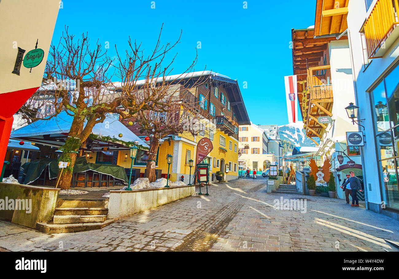 ZELL AM SEE, AUSTRIA - FEBRUARY 28, 2019: The old street of popular mountain resort with colorful edifices, cafes, restaurants, sport stores and souve Stock Photo
