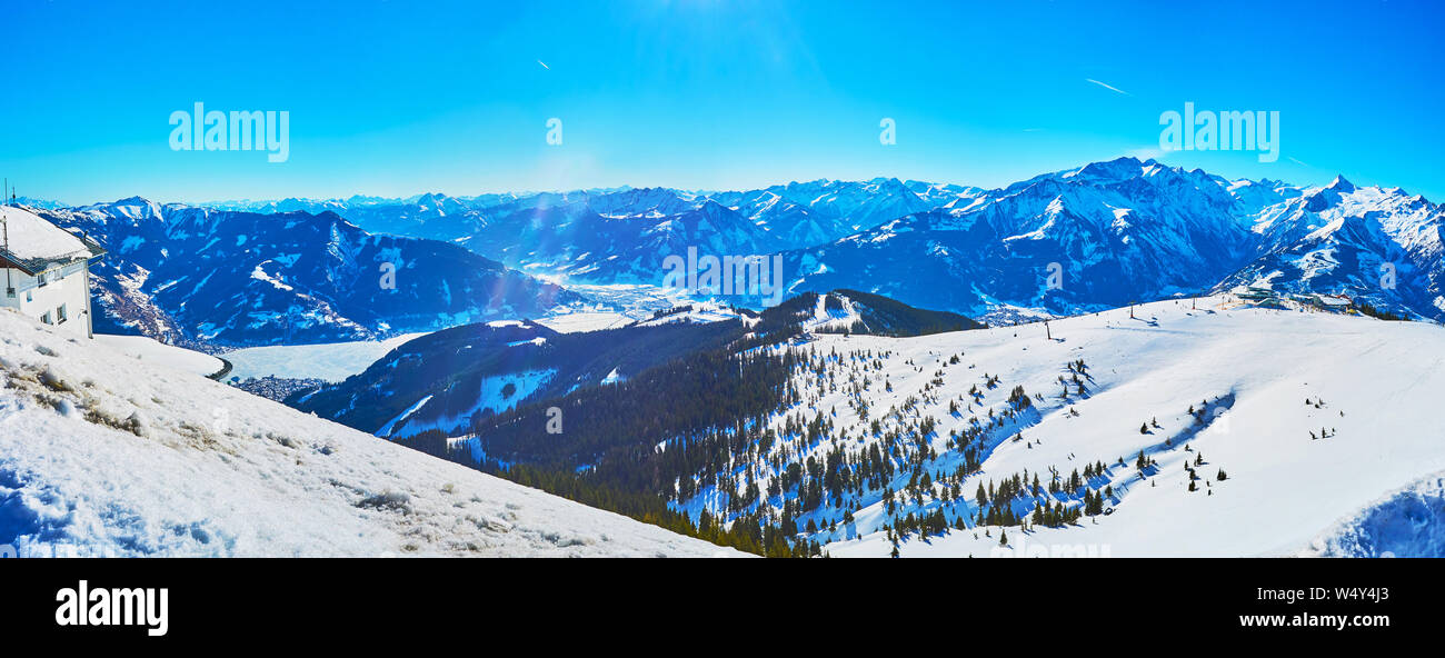 Panorama of Zell am Zee resort from the top of Schmittenhohe mount with a view on frozen Zeller see (lake) and snowy Alps, Austria. Stock Photo