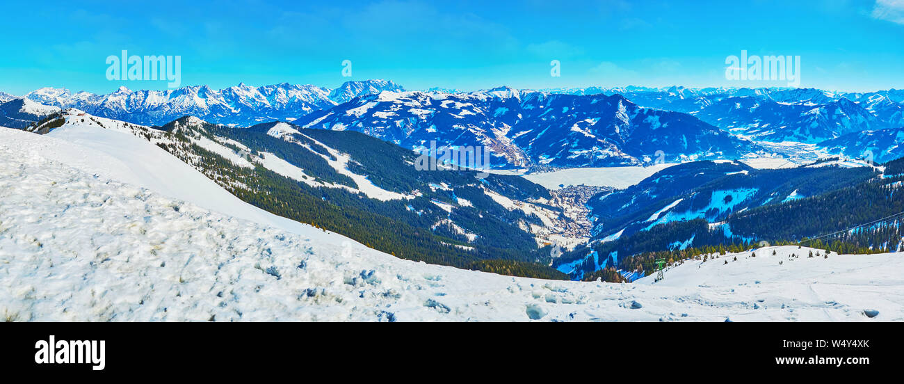 The stunning winter landscape from the top of Schmitten mount with a view on frozen Zeller see, Alpine slopes and sharp rocky peaks, Zell am See, Aust Stock Photo