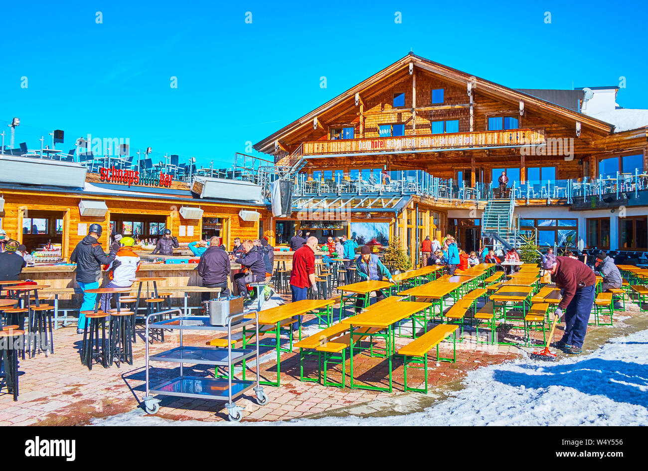 ZELL AM SEE, AUSTRIA - FEBRUARY 28, 2019: The sportsmen and tourists in open air bar-restaurant, located on top of Schmitten mountain, on February 28 Stock Photo