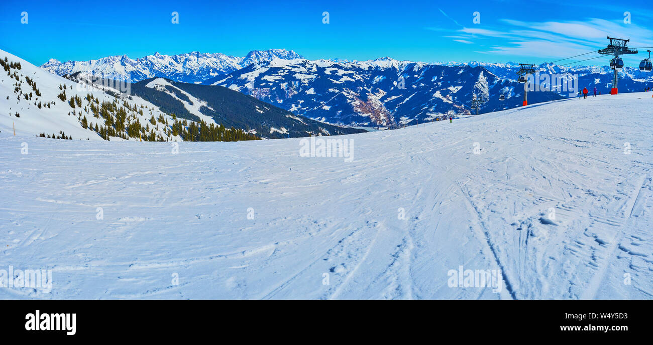 Panorama of Schmittenhohe mountain gentle slope,the groomed piste is covered with chaotic ski prints, leaved by numerous sportsmen, Zell am See, Austr Stock Photo