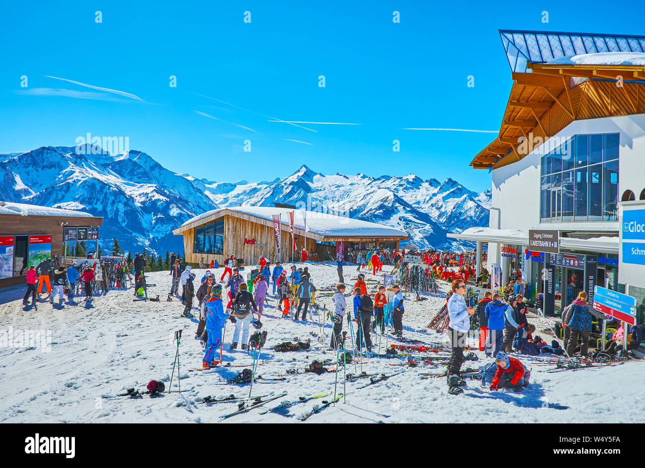 ZELL AM SEE, AUSTRIA - FEBRUARY 28, 2019: The sportsmen take a rest at the Areitbahn cableway station after the downhill from Schmittenhohe mount to A Stock Photo