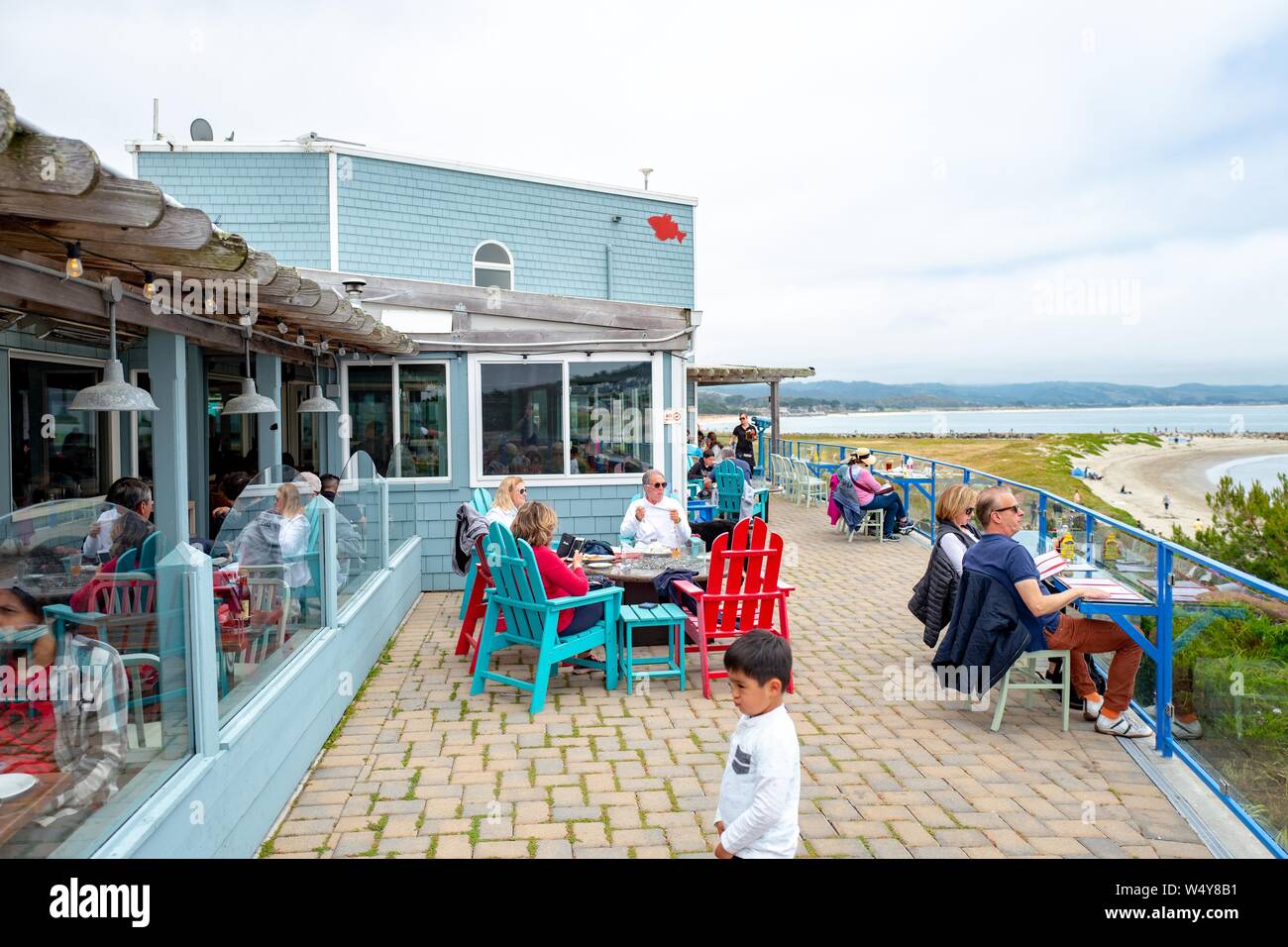 People dine outdoors overlooking the Pacific Ocean at the iconic Sam's Chowder House restaurant in Half Moon Bay, California, June 16, 2019. () Stock Photo