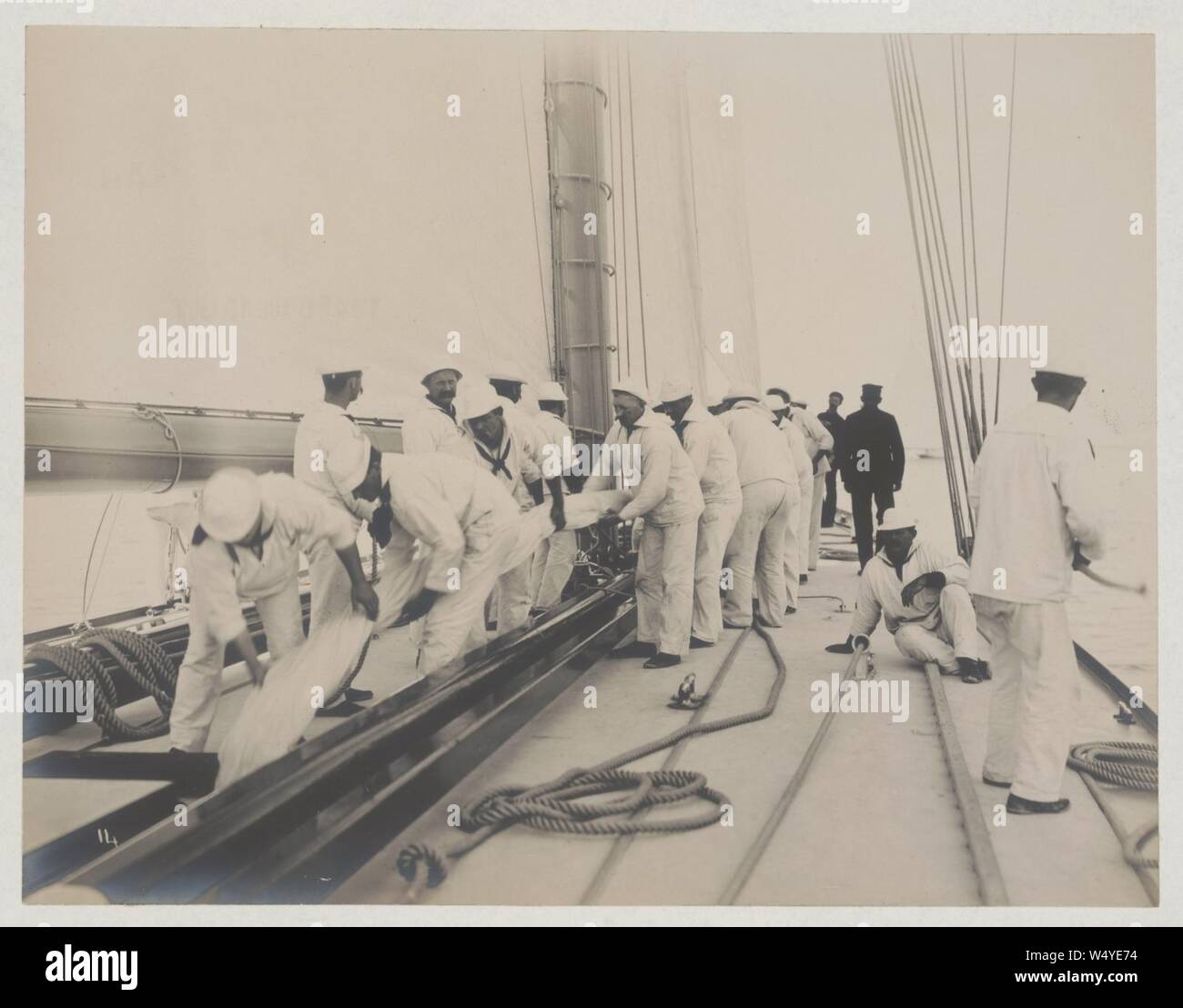 Crew handling sail on the yacht Reliance, winner of 1903 America's Cup ...