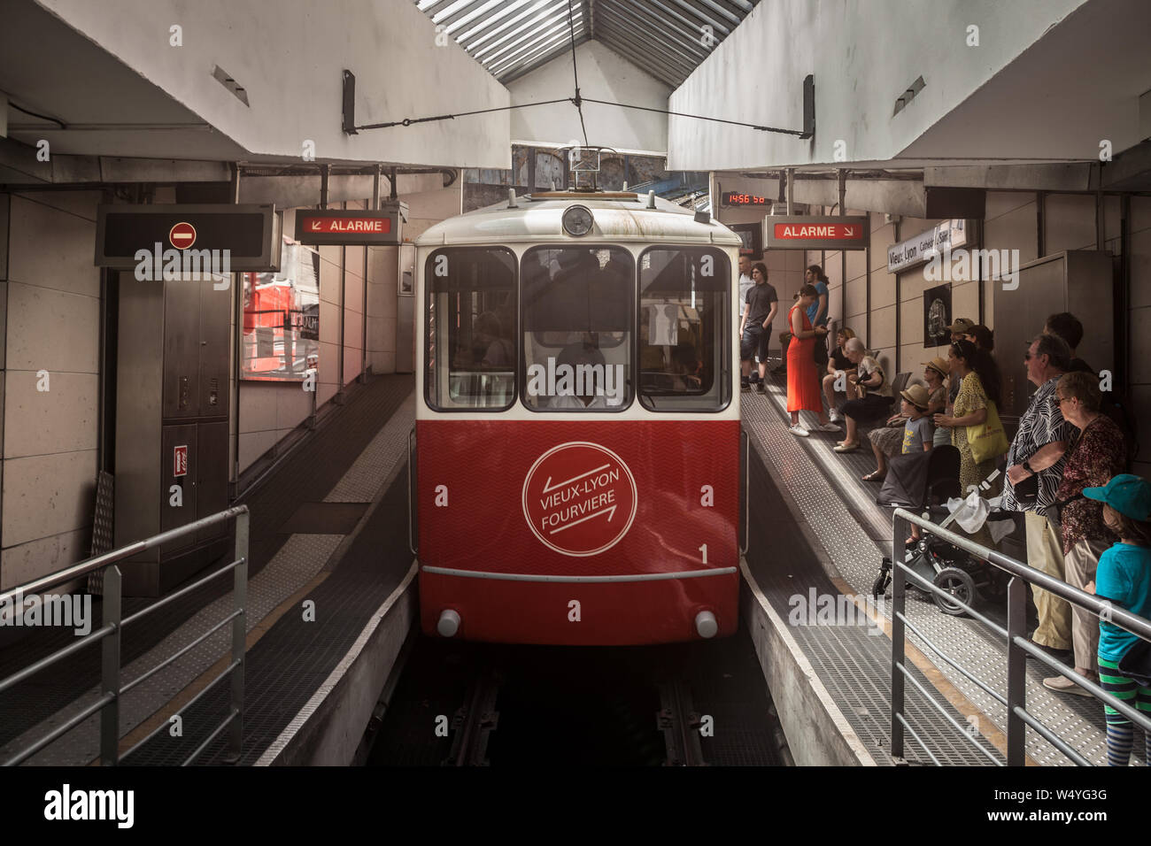 LYON, FRANCE - JULY 19, 2019: Lyon Funicular Railway entering the station of Old Lyon with tourists preparing to enter, before bringing them to Fourvi Stock Photo