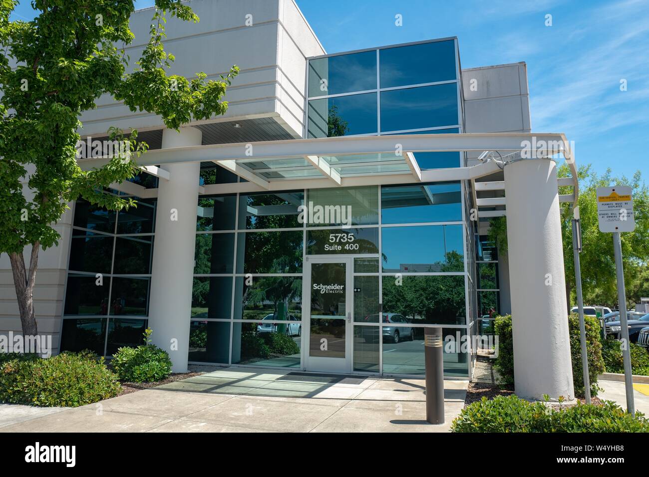 Facade with sign and logo at office of electrical automation company Schneider Electric in Pleasanton, California, July 2, 2019. () Stock Photo