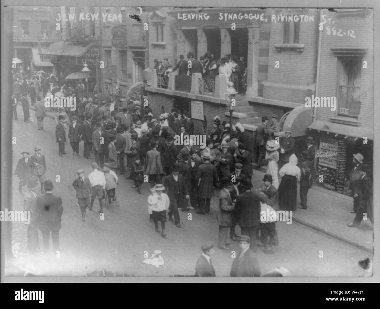 Crowd leaving synagogue on Jewish New Year. Rivington St., East Side, New York City. Stock Photo