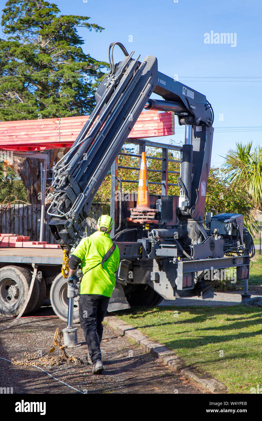 Sheffield. Canterbury, New Zealand, July 25 2019: Builders unload roof trusses that have been delivered by a Hiab truck to a building site Stock Photo