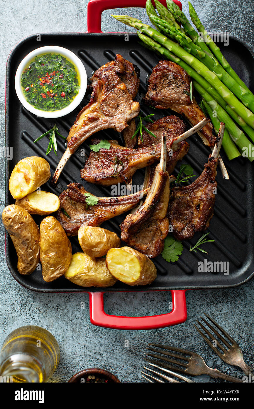 Grilled lamb chops with green herb sauce, asparagus and potatoes Stock