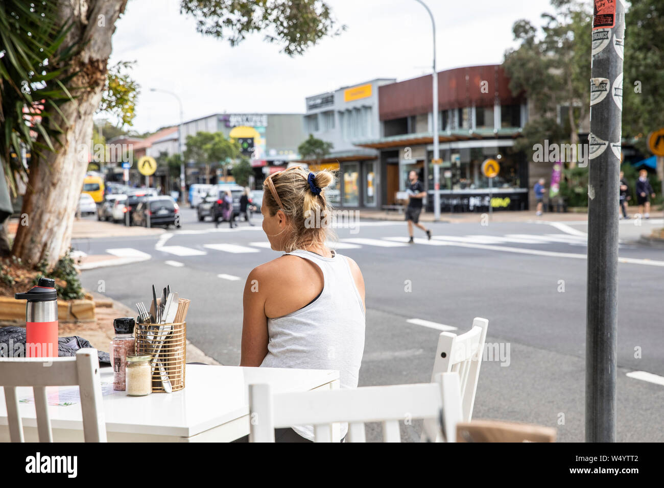 Sydney, young woman sits at a cafe after a morning workout,Australia Stock Photo