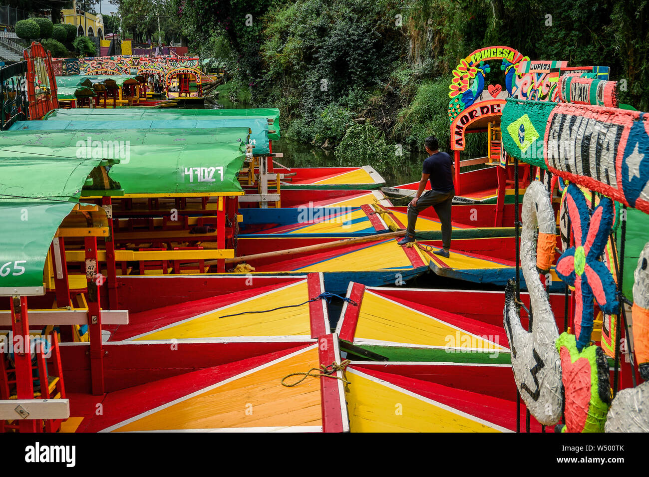 Xochimilco, Mexico City, June 25, 2019 -Man standing on trajinera moored in Embarcadero Nativitas Stock Photo