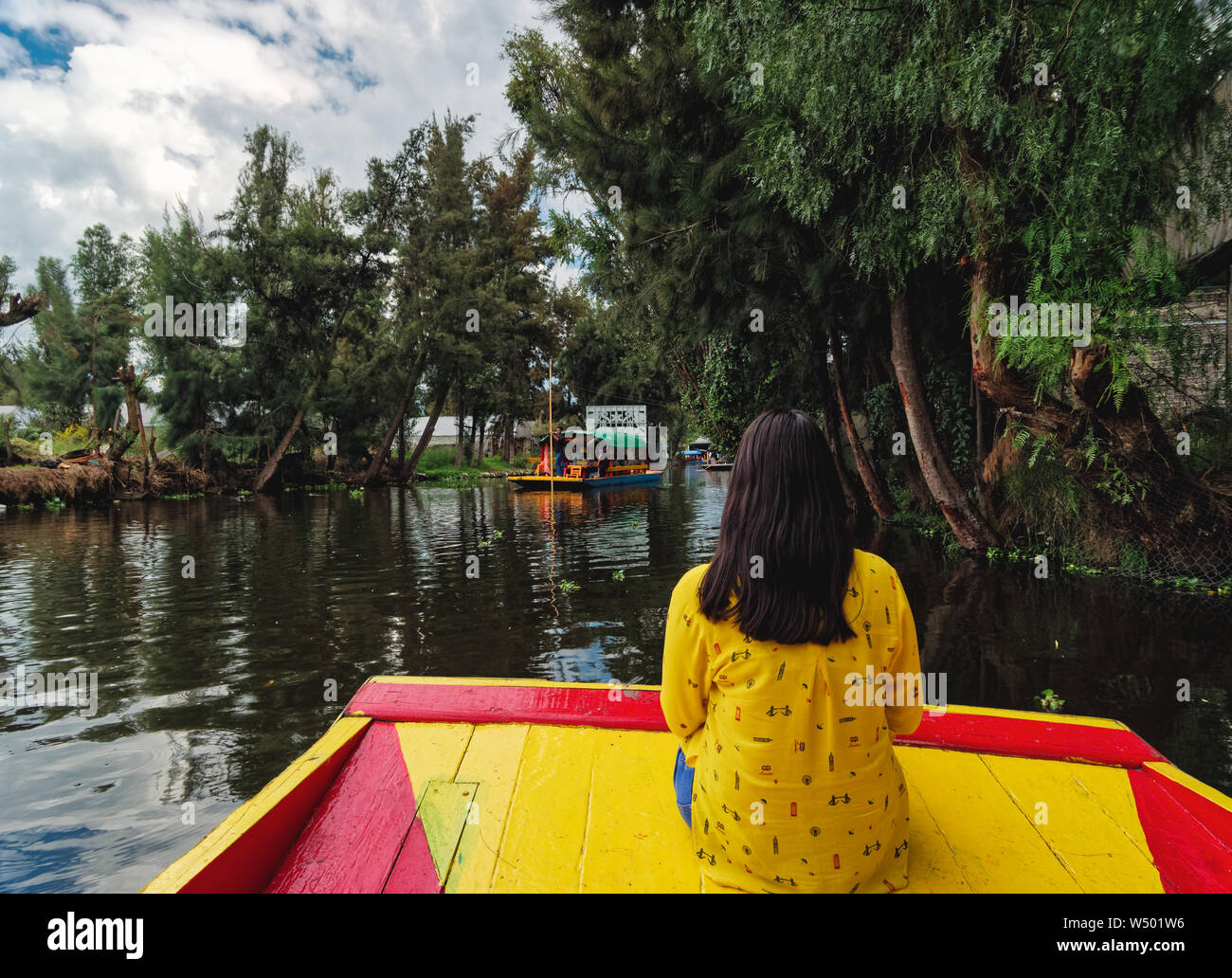 Xochimilco, Mexico City, June 25, 2019 - Young latin woman sitting on trajinera enjoying the Xochimilco canal tour. Stock Photo