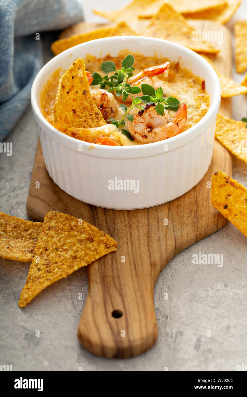 Spicy seafood dip in a ramekin with corn chips Stock Photo Alamy