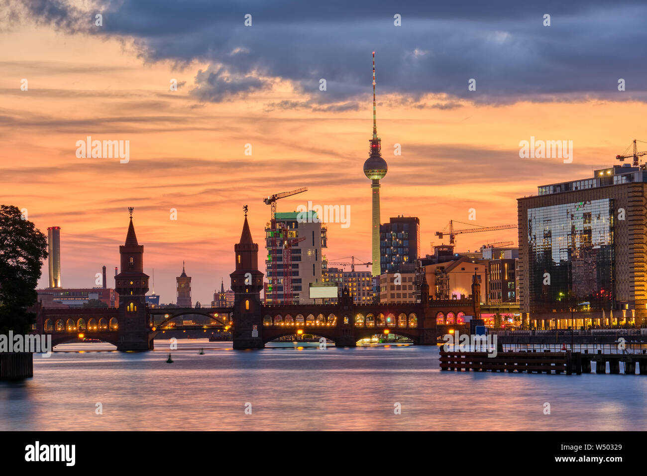 Beautiful sunset at the Oberbaum Bridge and the famous Television Tower in Berlin Stock Photo