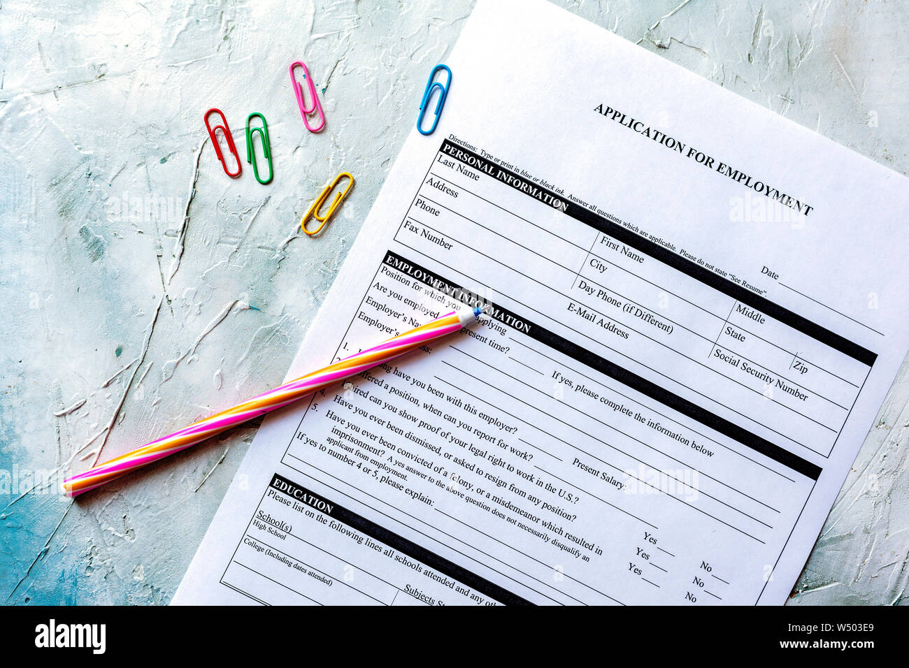 standard application for employment hr hiring applying concept job application form top view multicolored paper clips and pen stock photo alamy