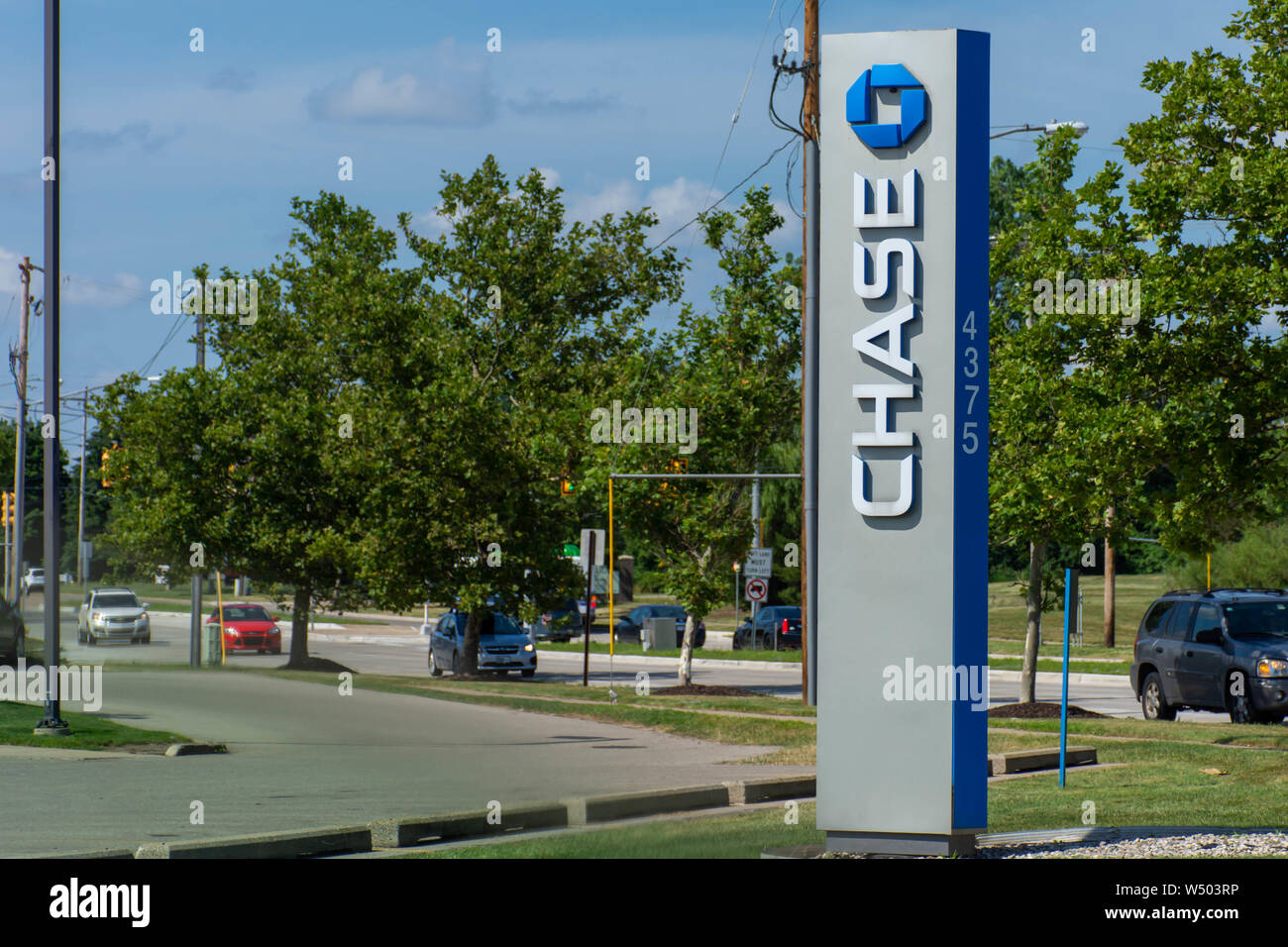 'Grand Rapids, Michigan/United States of America - 07/17/2019: Blue Chase Bank Sign with drive thru, atm and flowers on green grass and blue sky.' Stock Photo