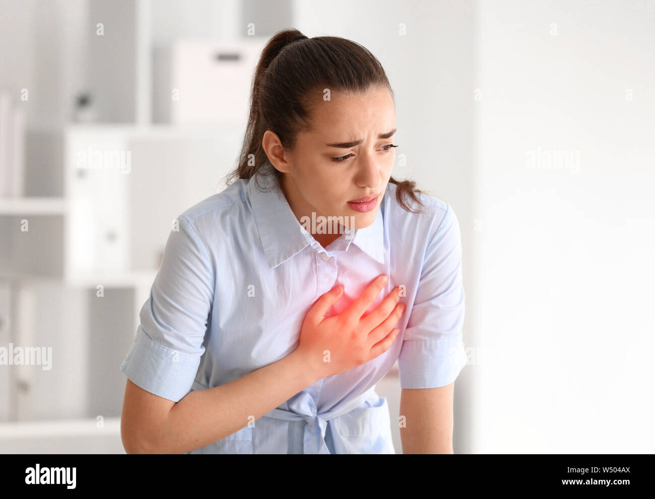 Young Woman Suffering From Heart Attack At Home Stock Photo Alamy   Young Woman Suffering From Heart Attack At Home W504AX 