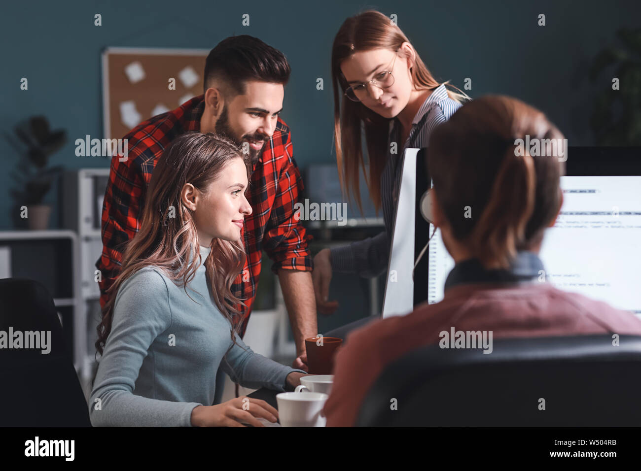 Team of programmers working in office Stock Photo - Alamy