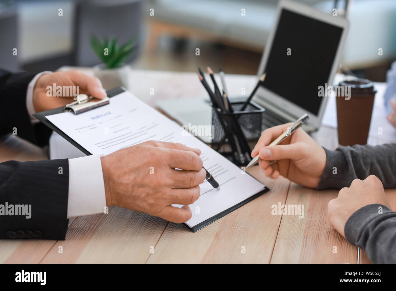 Man signing documents at notary public office Stock Photo Alamy
