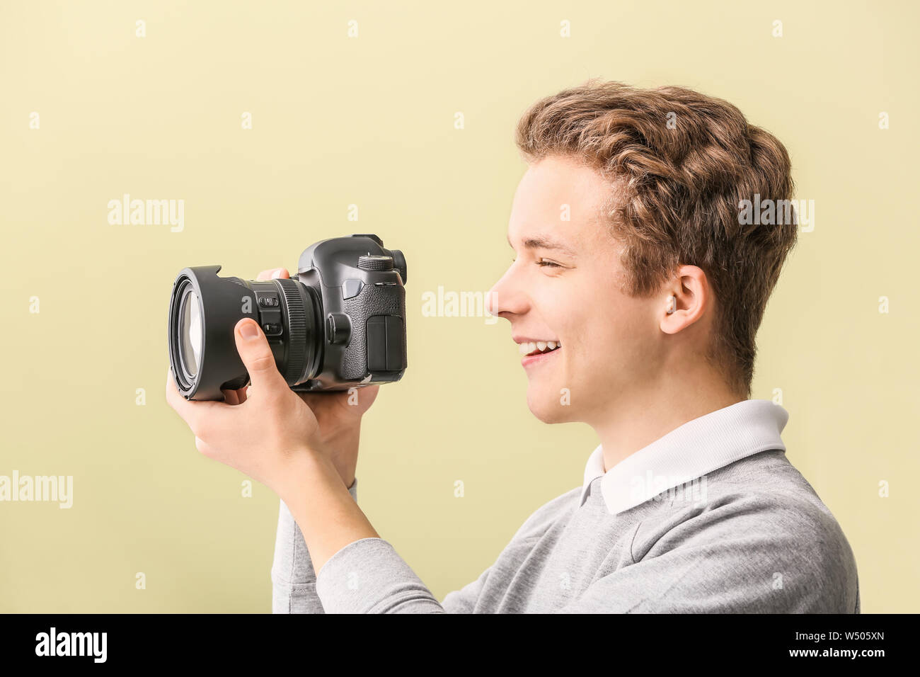Teenage boy with photo camera at home Stock Photo - Alamy