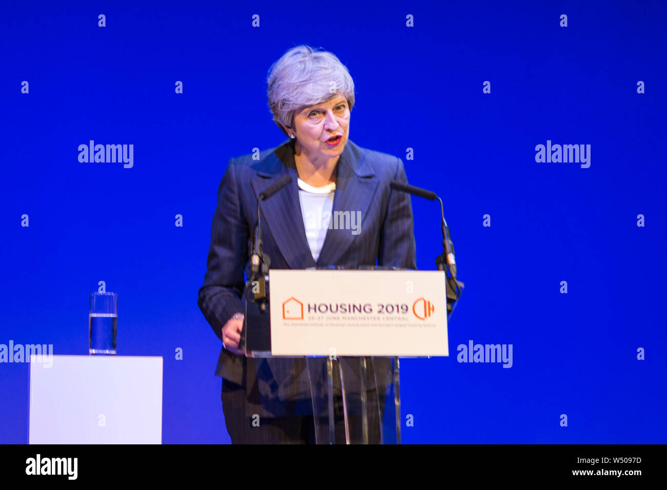 Prime Minister Theresa May on stage delivering her speech to the CIH conference in one of her last appearances as Prime Minister Stock Photo